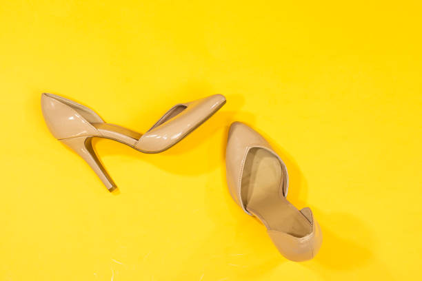 istock pink pump hight heeled isolated on yellow background 1346708703