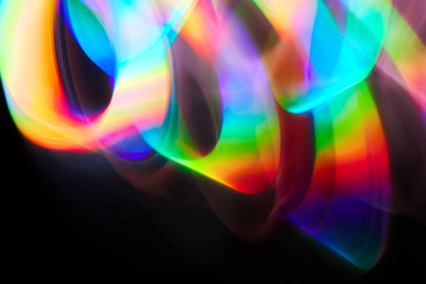 istock Blurred bright rainbow light. Lens or prism dynamic flare. Draving shiny spots. Dark background. Illuminated burst of multicolor light. 1346708774
