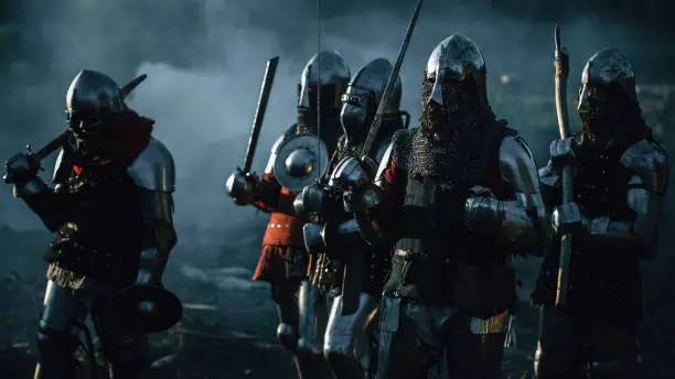 Epic Invading Army of Medieval Soldiers Marching Through Forest. Armored Warriors with Swords on a Kill and Destroy Mission. War, Battle, Invasion, Conquest. Cinematic Historical Reenactment