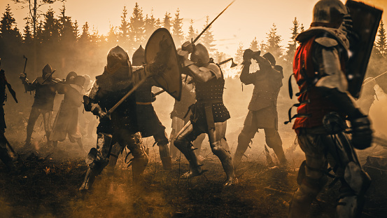 Epic Battlefield: Armies of Medieval Knights Fighting with Swords. Dark Ages Warfare. Action Battle of Armored Warrior Soldiers, Killing Enemies. Cinematic Historical Reenactment.