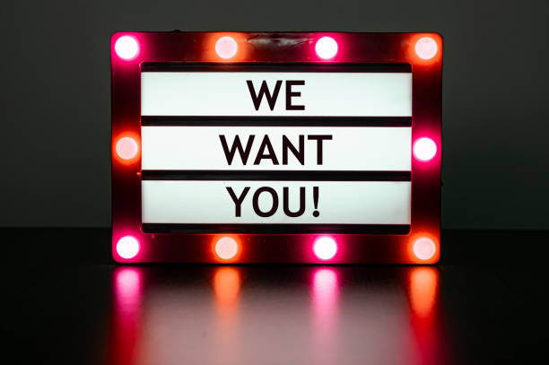 Lightbox with red lights in dark room with words - we want you stock photo