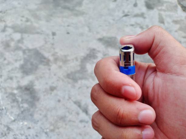 istock someone's hand holding a gas lighter 1346712262