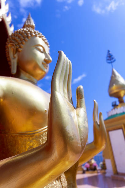 istock Beautiful golden Buddha statue with a sky as a backdrop 1346713156