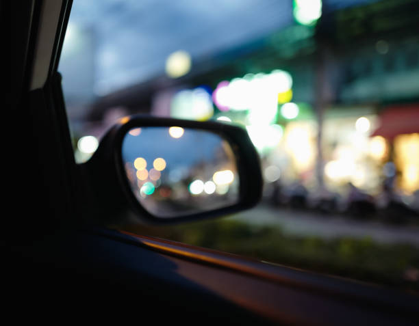istock Defocused side view mirror car with bokeh of street light 1346713538