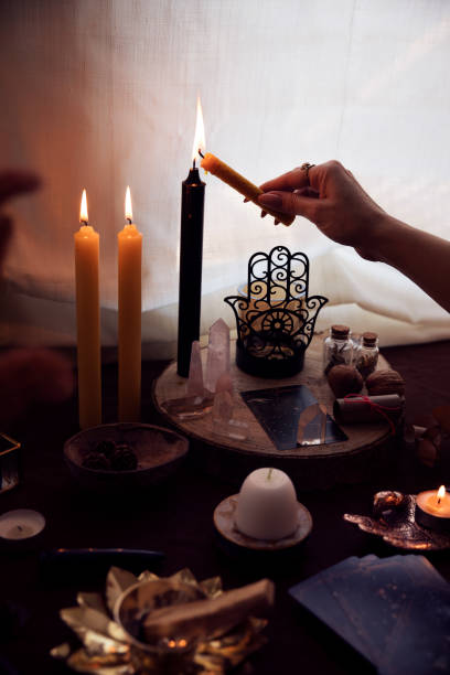 istock A woman lights a black candle on her witch altar to perform an esoteric ritual 1346716011