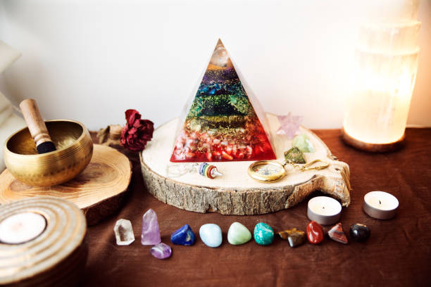 istock Altar with a protective pyramid of electromagnetic waves, several semiprecious stones in the colors of the rainbow 1346716098