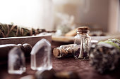 istock Detail of two glass jars with some medicinal herbs on an altar to perform rituals 1346716162