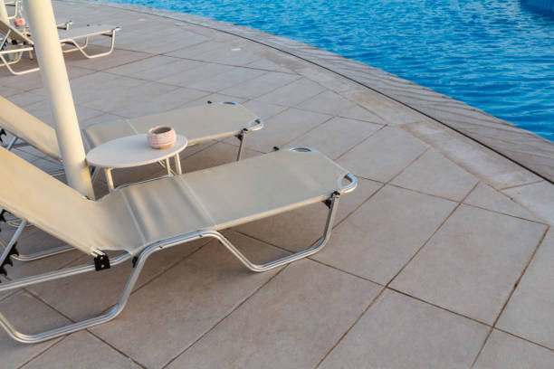 istock Empty deck chairs near the pool of a hotel. 1346716265