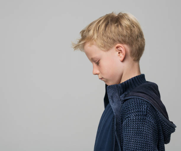 istock Profile of thoughtful boy looking down 1346716754