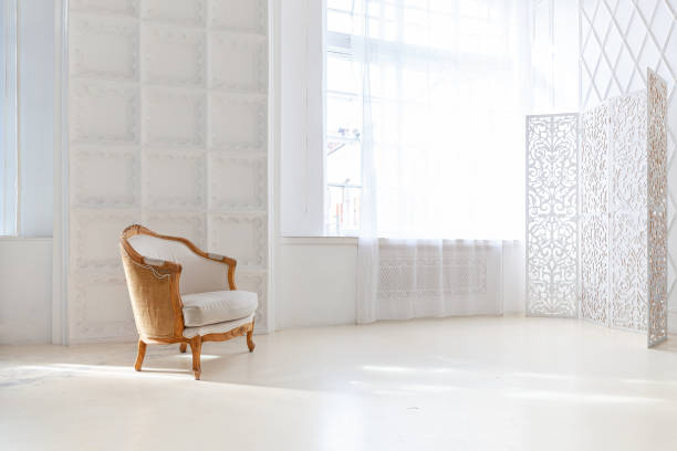 istock Stylish loft bedroom interior. Spacious design apartment with light walls large windows and armchair. Clean modern decoration with elegant furniture in minimalist Scandinavian style 1346717931