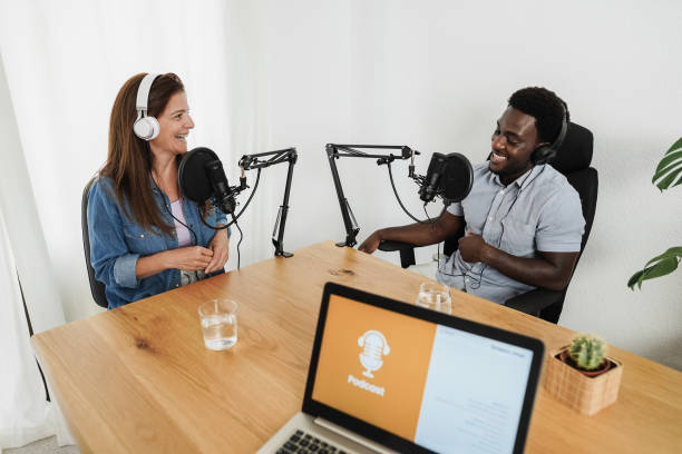 istock Multiracial hosts streaming podcast together at home studio - Focus on woman face 1346718661