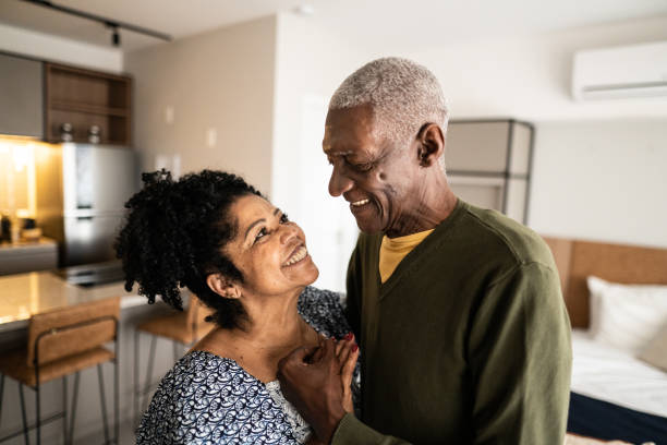 istock Senior couple looking at each other at home 1346718937