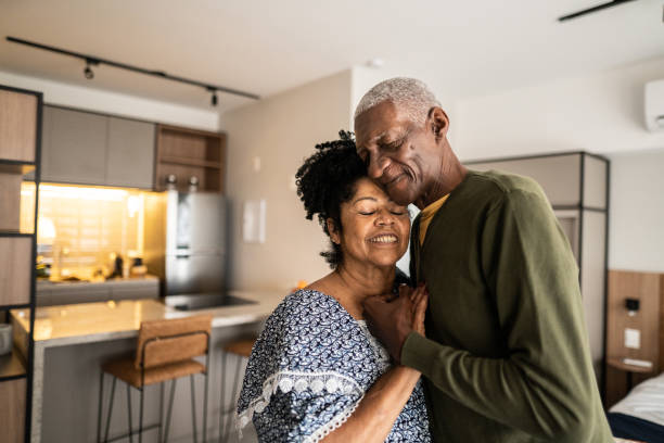 istock Senior couple embracing each other at home 1346718957
