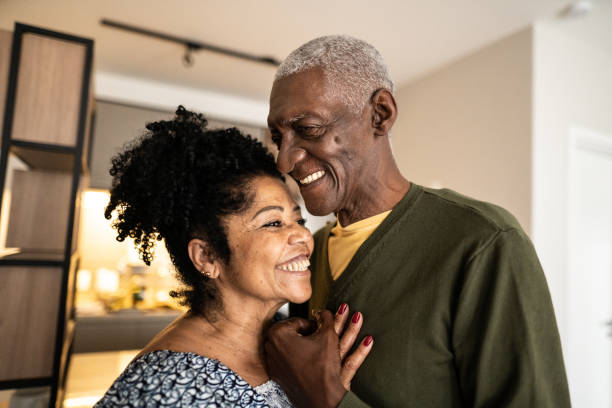istock Senior couple embracing each other at home 1346718964