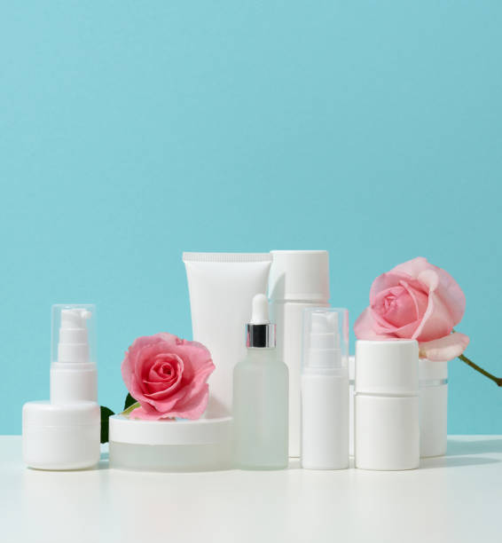 istock jar, bottle and empty white plastic tubes for cosmetics on a white table. Packaging for cream, gel, serum, advertising and product promotion, mock up 1346723719