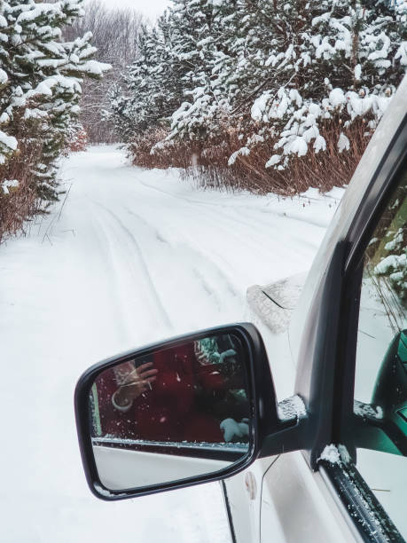 istock car mirror in front with view of snowed trail in forest 1346727997