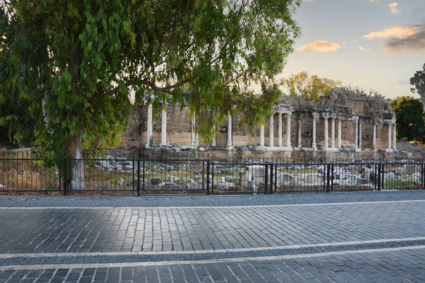 The monumental fountain, which is a part of the ancient city of Side, Antalya, Turkey. Selective Focus. No people. behind from road.