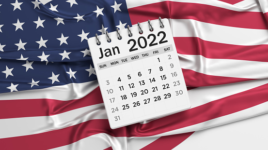 White-colored January calendar page and the American flag. Horizontal composition with copy space. Isolated with clipping path.