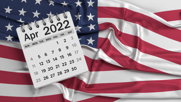istock White-colored April calendar page and the American flag. 1346733769