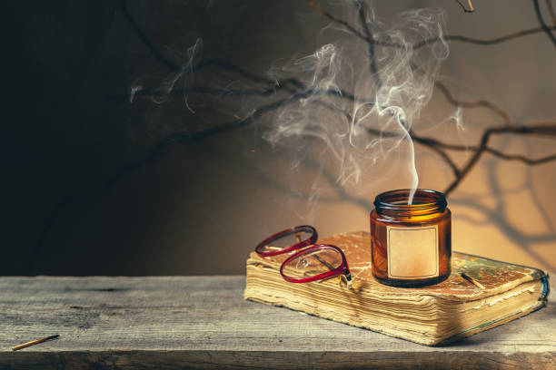 istock old antique book, glasses, recently blown candle 1346735462