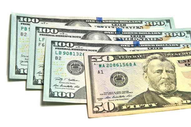 istock Small stack of 100 and 50 dollar bills, papers, finance. 1346738591