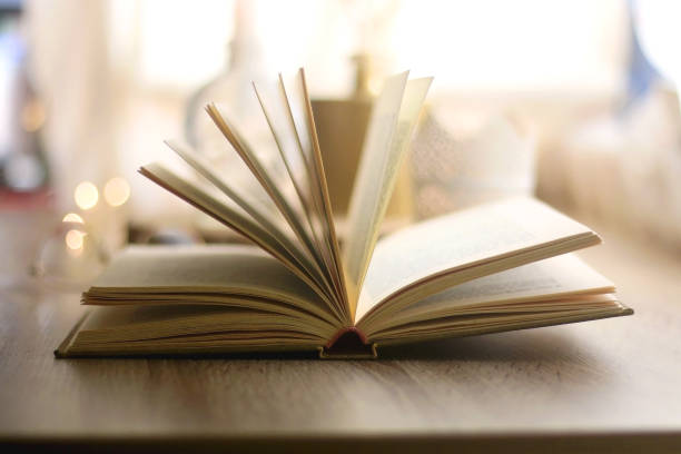 istock Book, Reading Glasses and Candles 1346740873