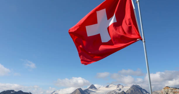 istock Swiss flag blows in the wind on a rocky summit 1346742216