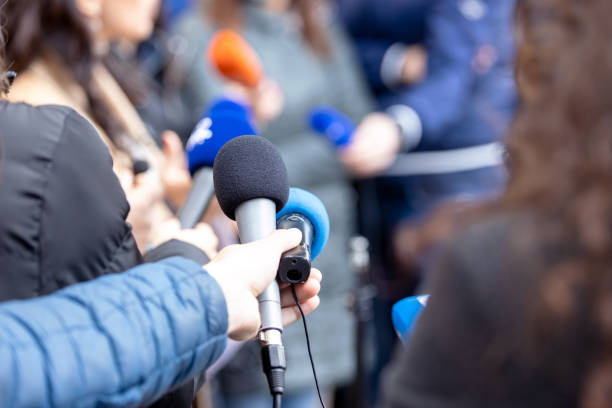 Journalists at news conference or media event, microphone in the focus Reporters at press conference or media event, microphone in the focus publicity event stock pictures, royalty-free photos & images