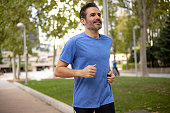Handsome fit middle aged man of Hispanic ethnicity exercising outdoors