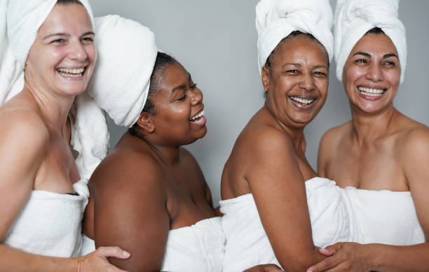 istock Multiracial women embracing together inside beauty studio while doing spa day 1346746701