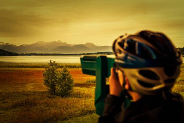 istock teenager looking through binoculars to the chiemgauer alps 1346746901