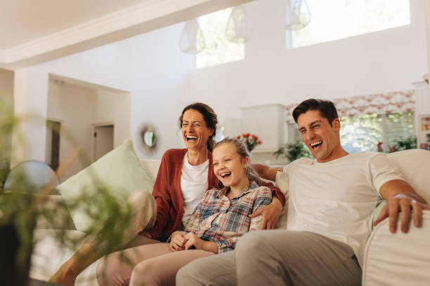 istock Family watching comedy tv show 1346747783
