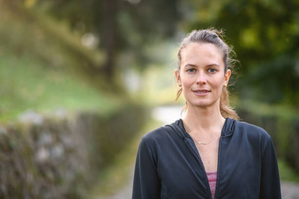 istock Woman jogging and exercising in the park 1346749171