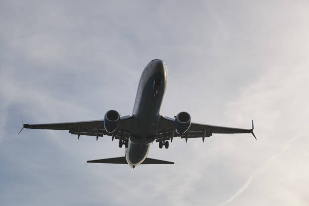 istock plane lands close-up, airplane in the sky 1346749331