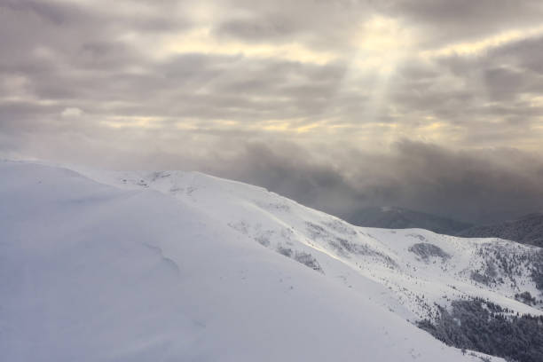 Winter landscape. Sunlight passes through the clouds.