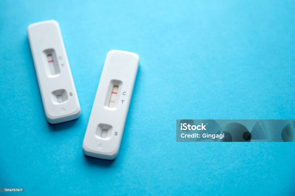 Coronavirus antigen rapid tests device, with positive and negative result on a blue background. Copy space. Coronavirus antigen rapid tests device, with positive and negative result on a blue background. Copy space for text Coronavirus Stock Photo