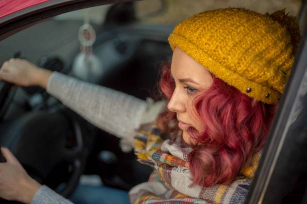 istock Young woman driving car 1346760144
