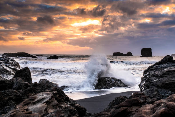 istock a wave breaks on a rock on the Kirkjufjara coast in Vik, Iceland 1346760399