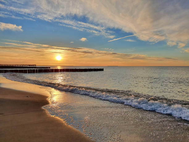 istock Beach on calm Baltic Sea under scenic sunset sky 1346762118