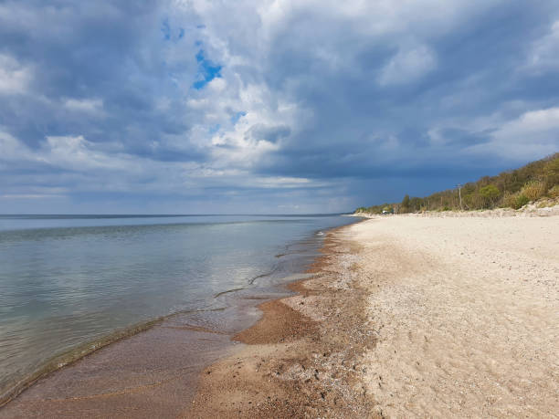 istock Baltic sea beach with calm waves and cloudy sky 1346762895