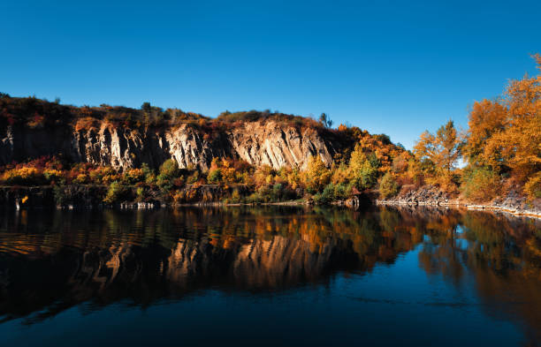 istock Old flooded quarry in autumn 1346769438