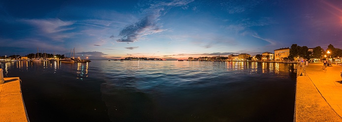 Image of colorful sunset from the harbor of the Croatian coastal town of Porec in summer