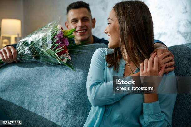 Romantic Young Man Surprising His Girlfriend With A Bouquet Of Beautiful Flowers Stock Photo - Download Image Now