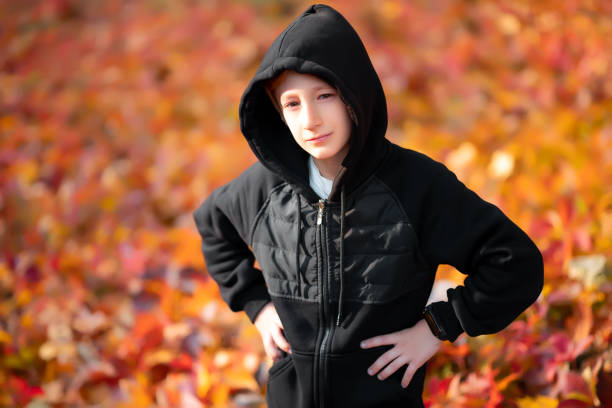 istock a boy in an autumn park 1346773623