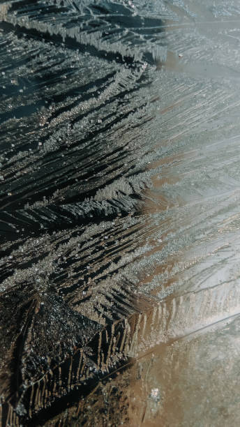 istock Macro shot of ice flowers crystals formed on window 1346774371