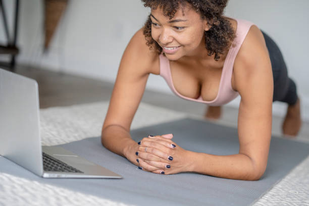 istock Woman Planking at Home with a Virtual Class 1346776529