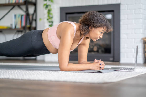 istock Woman Planking at Home with a Virtual Class 1346776533