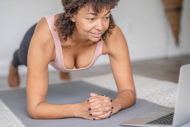 istock Woman Planking at Home with a Virtual Class 1346776549