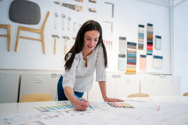 istock Happy interior designer sketching at her office 1346781637