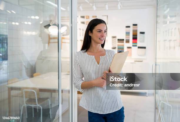 Thoughtful Interior Designer Working At Her Office Stock Photo - Download Image Now - Home Interior, Assistant, Clipboard